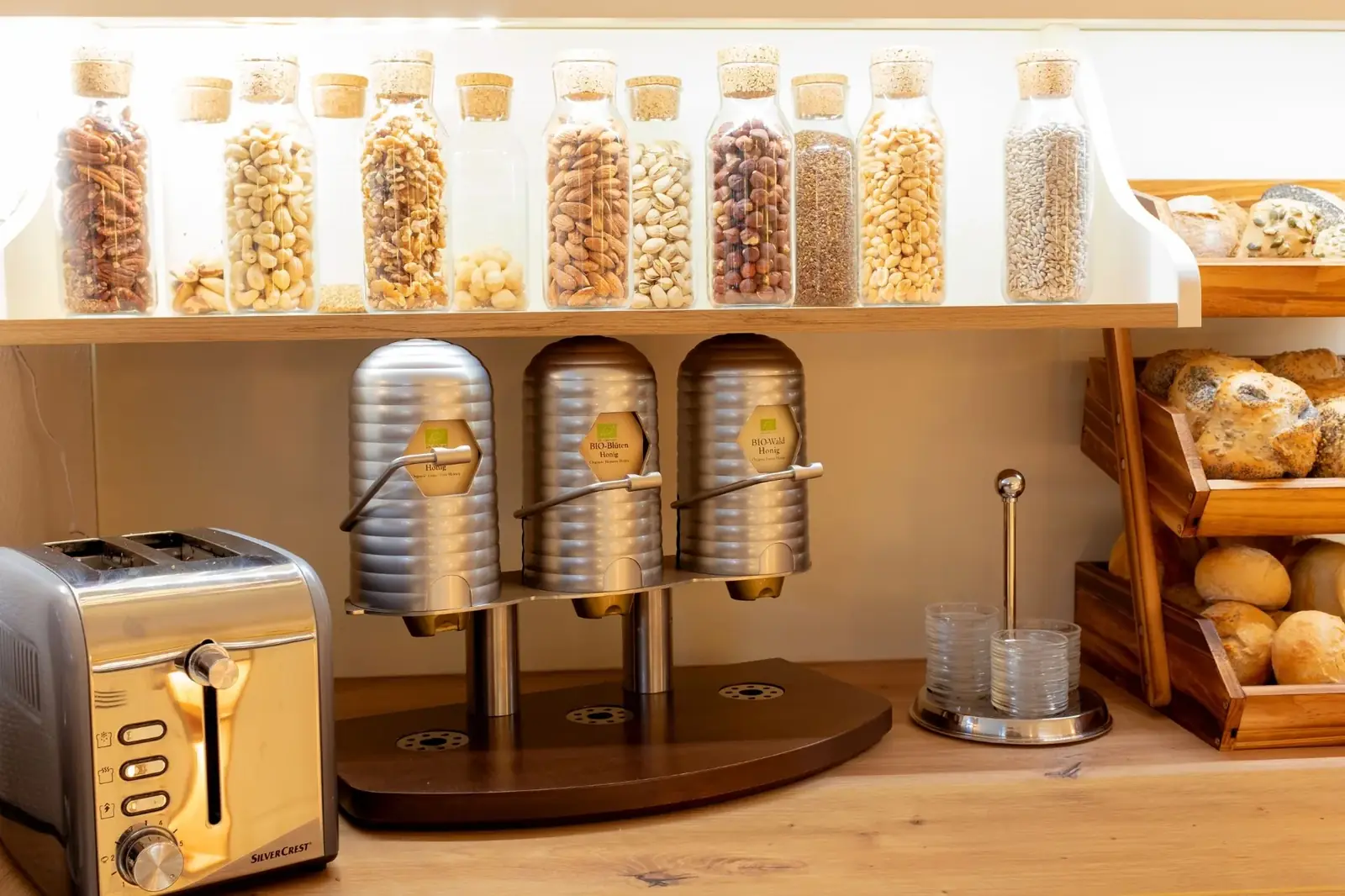 Muesli station with cereal dispensers, nuts, seeds and toaster – Hotel Potsdam Katharinenholz