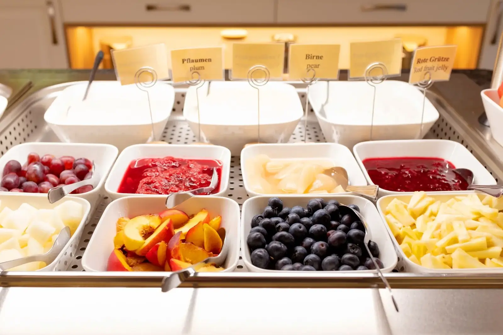 Fresh fruit, red fruit jelly and compote at the breakfast buffet – Hotel Potsdam Katharinenholz